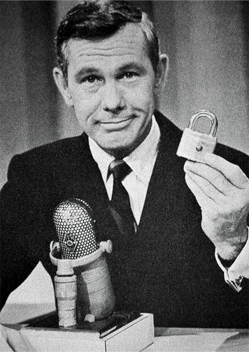 Johnny Carson holding a Master Lock 41w padlock.