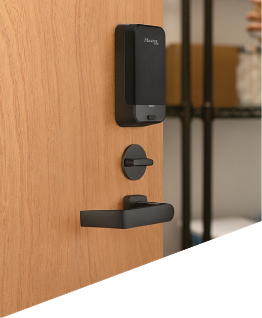 Close up of medical supply closet with door open, keypad door lock on door and silhouette in scrubs