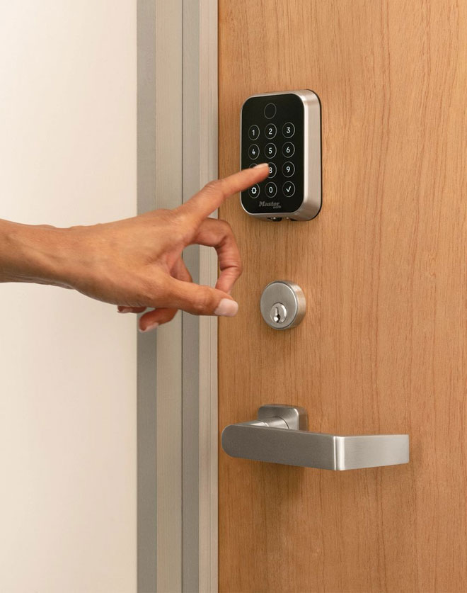 Close up of hand almost pushing buttons on interior keypad door lock
