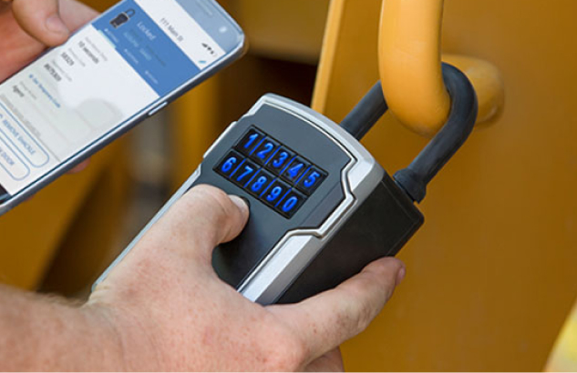 A Master Lock Bluetooth lock box being unlocked with a smartphone