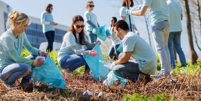 A volunteer picking up trash during a community clean up.